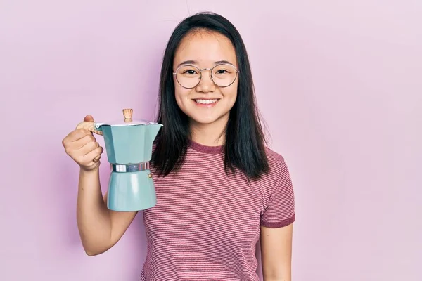 Young Chinese Girl Holding Italian Coffee Maker Looking Positive Happy — Foto Stock