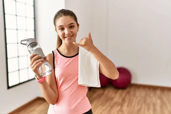 Young Brunette Teenager Wearing Sportswear Holding Water Bottle Smiling Doing — Stockfoto