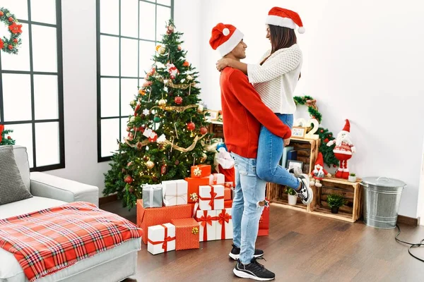 Young Latin Couple Hugging Standing Christmas Tree Home — Stok fotoğraf