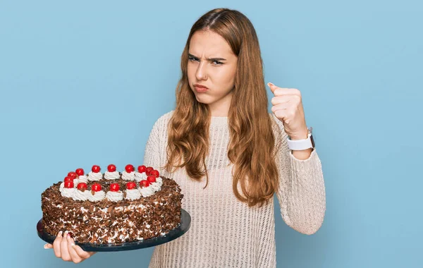 Young Blonde Woman Celebrating Birthday Holding Big Chocolate Cake Annoyed — Stock Photo, Image