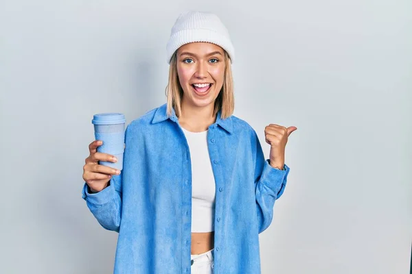 Beautiful Blonde Woman Drinking Take Away Cup Coffee Pointing Thumb — Fotografia de Stock