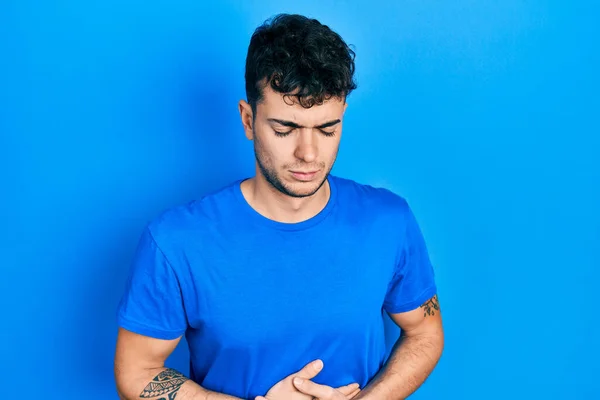 Homem Hispânico Jovem Vestindo Camisa Azul Casual Com Mão Estômago — Fotografia de Stock