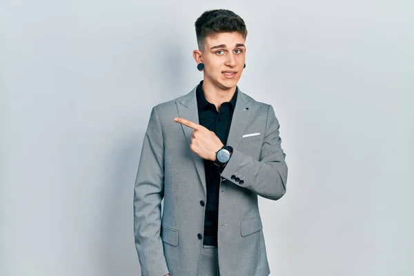 Young Caucasian Boy Ears Dilation Wearing Business Jacket Pointing Aside — Stock Photo, Image
