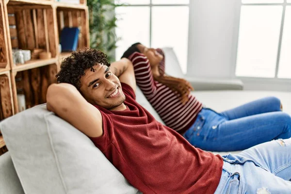 Young Latin Couple Smiling Happy Relaxed Hands Head Sitting Sofa — Stock Photo, Image