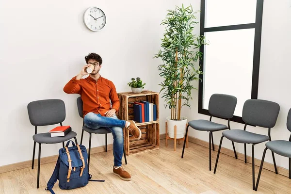 Young Hispanic Man Drinking Coffee Waiting Room — Stockfoto