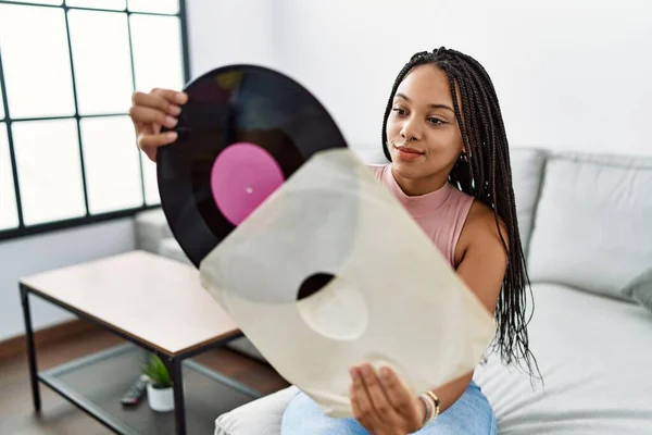 Young African American Woman Smiling Confident Holding Vinyl Disc Home — стоковое фото