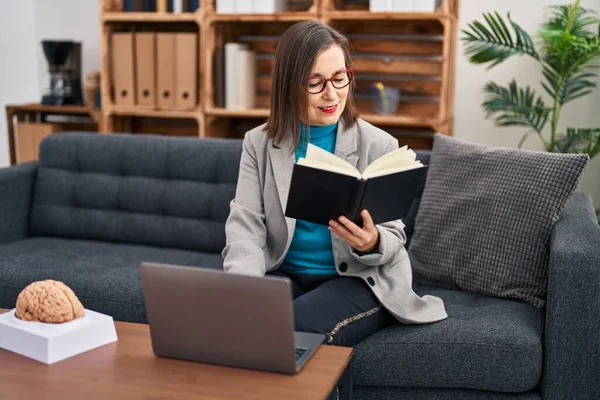 Psicólogo Mulher Meia Idade Usando Livro Leitura Laptop Centro Psicologia — Fotografia de Stock