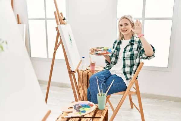 Young Artist Woman Painting Canvas Art Studio Waiving Saying Hello — Stock Photo, Image