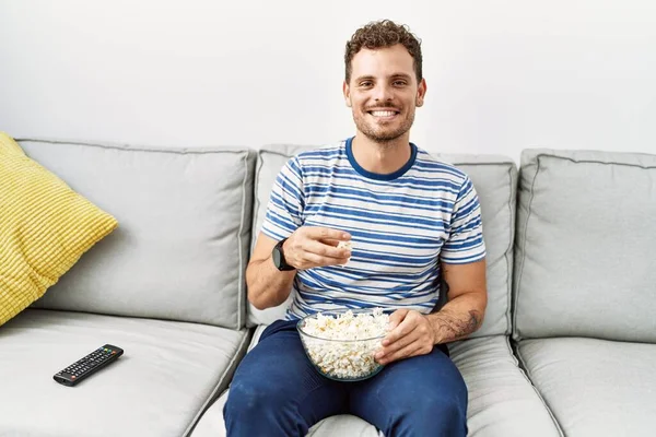 stock image Young hispanic man smiling confident watching movie at home