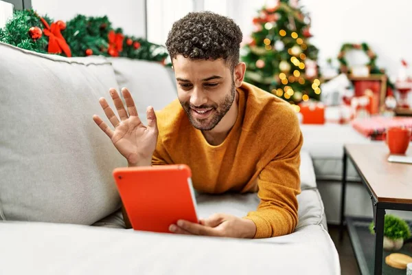 Young Arab Man Having Video Call Lying Sofa Christmas Tree — Stockfoto