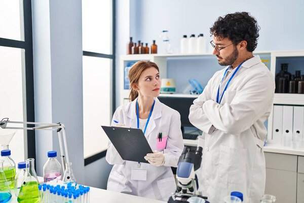 Man and woman scientist partners working at laboratory