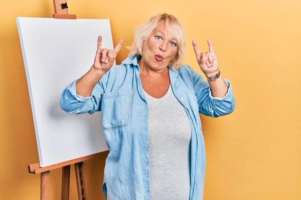 Middle Age Blonde Woman Standing Painter Easel Stand Shouting Crazy — Stock Photo, Image