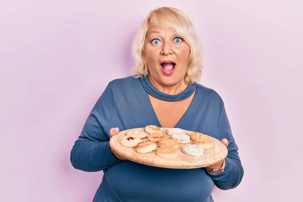 Middle Age Blonde Woman Holding Tray Cake Sweets Afraid Shocked — Stock Photo, Image