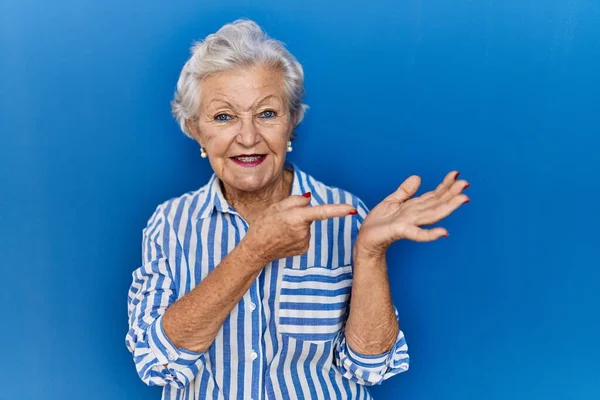 Seniorin Mit Grauen Haaren Steht Erstaunt Vor Blauem Hintergrund Und — Stockfoto