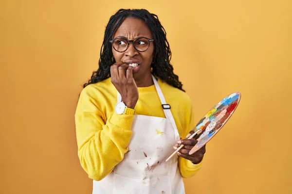 African Woman Holding Painter Palette Looking Stressed Nervous Hands Mouth — Stock Photo, Image