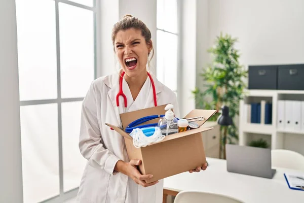Young Doctor Woman Holding Box Medical Items Angry Mad Screaming — Stock Photo, Image