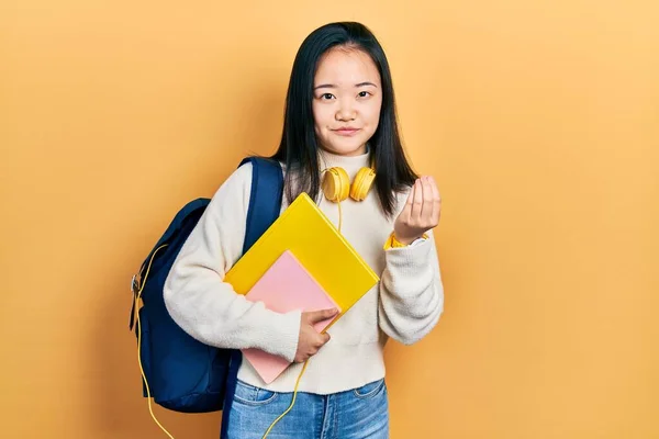 Young Chinese Girl Holding Student Backpack Books Doing Money Gesture — Stock Photo, Image