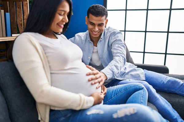 Jeune Couple Latin Attendant Bébé Toucher Ventre Assis Sur Canapé — Photo