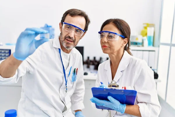 Middle Age Man Woman Partners Wearing Scientist Uniform Analyzing Sample — Stock Photo, Image