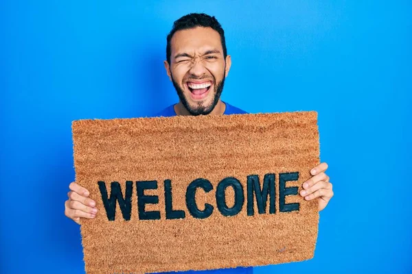 Hispanic Man Beard Holding Welcome Doormat Smiling Laughing Hard Out — Stock Photo, Image