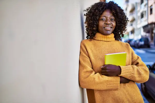 African American Woman Smiling Confident Holding Book Street —  Fotos de Stock