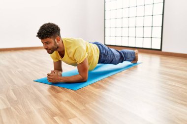 Genç Arap sporcu spor merkezinde karın kaslarını çalıştırmaya odaklan..