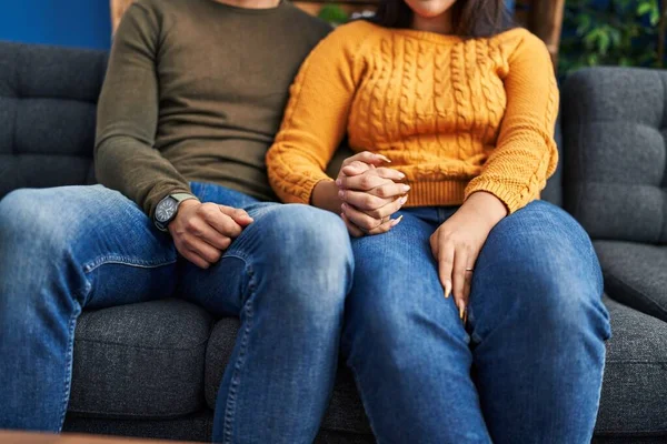 Man Woman Couple Sitting Sofa Hands Together Home — стоковое фото