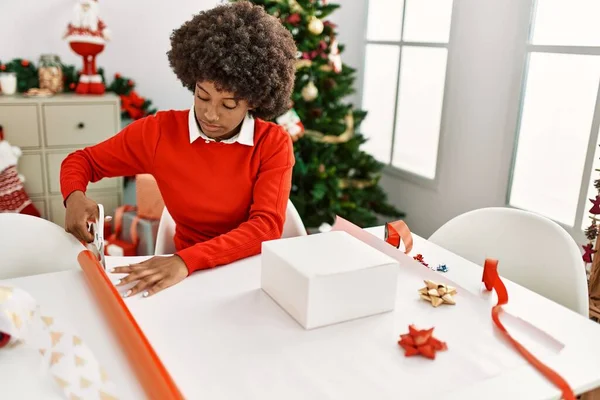 Young African American Woman Smiling Confident Packing Christmas Gift Home — Stock Photo, Image