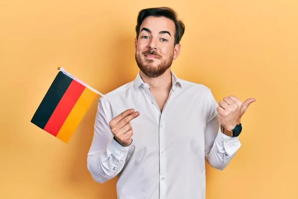 Handsome Caucasian Man Beard Holding Germany Flag Pointing Thumb Side — Stock Photo, Image