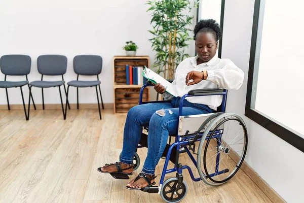 Young Black Woman Sitting Wheelchair Waiting Room Checking Time Wrist — Stockfoto