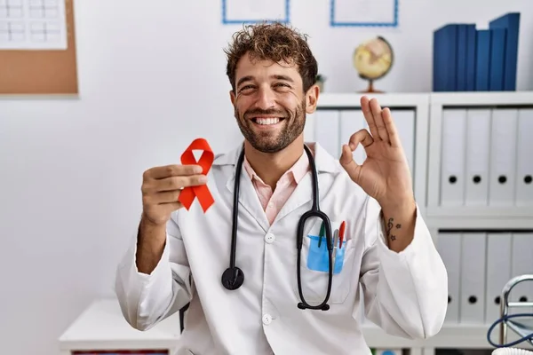 Genç Spanyol Doktor Klinikte Kırmızı Kurdele Tutuyor Parmaklarıyla Imza Atıyor — Stok fotoğraf