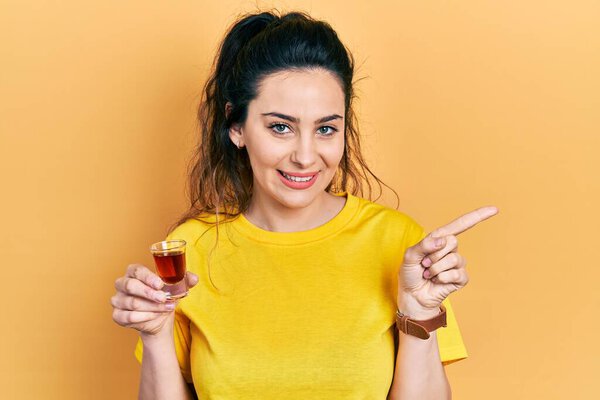 Young Hispanic Woman Drinking Whiskey Shot Smiling Happy Pointing Hand Royalty Free Stock Photos
