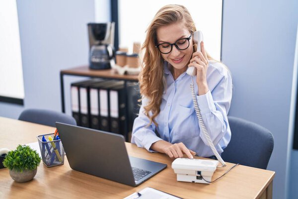 Young Blonde Woman Business Worker Using Laptop Talking Telephone Office Stock Photo