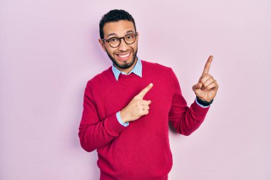 Sakallı, iş gömleği ve gözlüklü İspanyol bir adam iki eli de endişeli ve şaşırmış bir ifade takınıyor. 