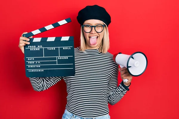 Beautiful Blonde Woman Holding Video Film Clapboard Megaphone Sticking Tongue — Stock fotografie