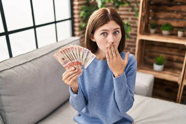 Young Brunette Woman Holding Colombian Pesos Covering Mouth Hand Shocked — Fotografia de Stock