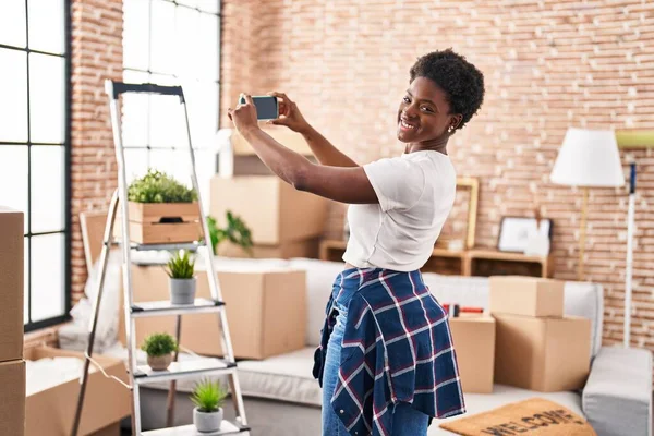African American Woman Smiling Confident Making Photo Smartphone New Home — Stok fotoğraf