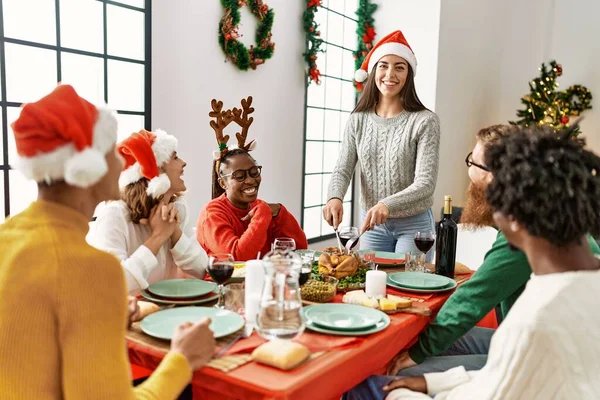 一群年轻人笑着高兴地吃着圣诞大餐 女人切烤火鸡在家吃 — 图库照片