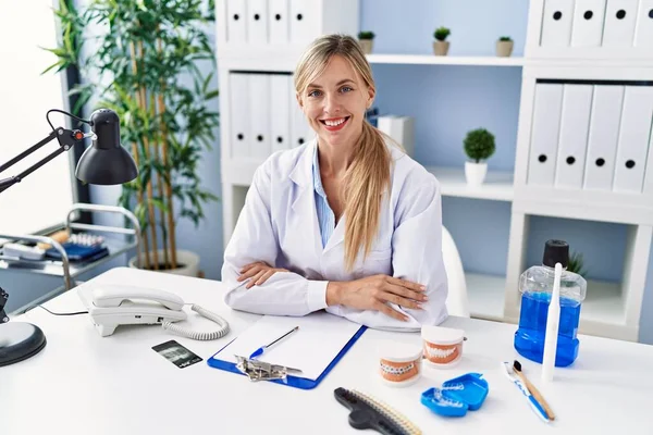 Young Blonde Woman Wearing Dentist Uniform Sitting Table Clinic — Stock fotografie