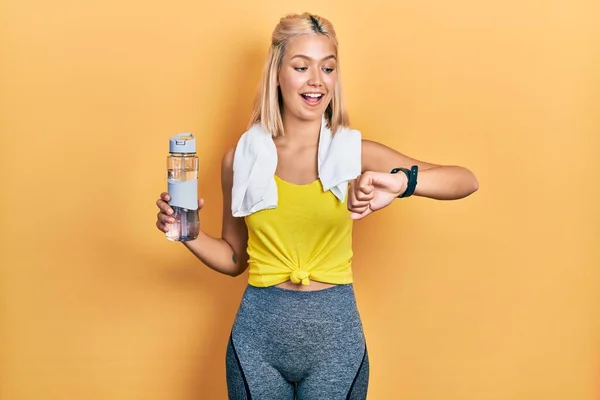 Beautiful blonde sports woman using smart watch celebrating crazy and amazed for success with open eyes screaming excited.