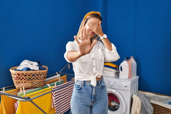 Young Blonde Woman Laundry Room Covering Eyes Hands Doing Stop — Stock Photo, Image