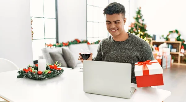 Young Hispanic Man Having Video Call Showing Gift Sitting Christmas — 스톡 사진