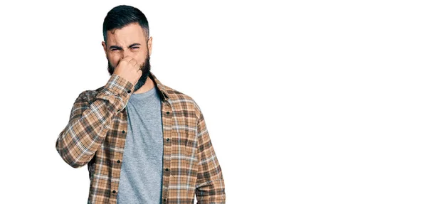 Homem Hispânico Com Barba Vestindo Camisa Casual Cheirando Algo Fedorento — Fotografia de Stock