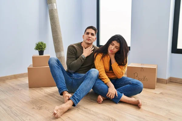 Young Couple Sitting Floor New Home Touching Painful Neck Sore — Stock Photo, Image