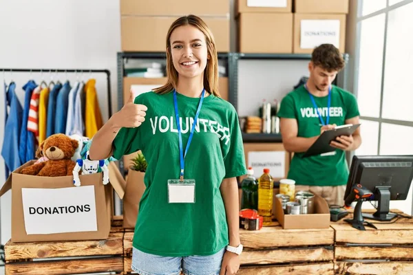 Young Blonde Girl Wearing Volunteer Shirt Donation Stand Doing Happy — Fotografia de Stock