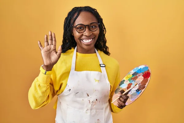 African Woman Holding Painter Palette Waiving Saying Hello Happy Smiling — Stock Photo, Image