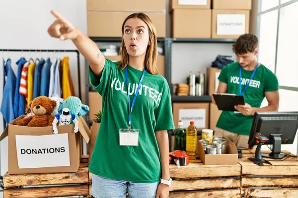 Young Blonde Girl Wearing Volunteer Shirt Donation Stand Pointing Finger — Fotografia de Stock