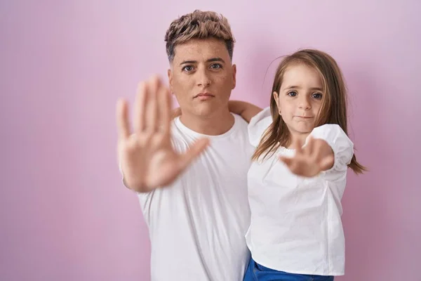 Young Father Hugging Daughter Pink Background Open Hand Doing Stop — ストック写真
