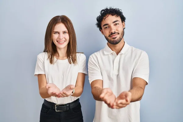 Young Couple Wearing Casual Clothes Standing Together Smiling Hands Palms — Stockfoto