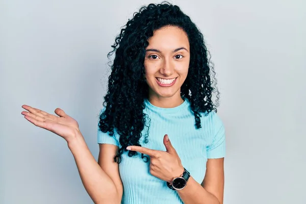 Young Hispanic Woman Curly Hair Wearing Casual Blue Shirt Amazed — Stockfoto